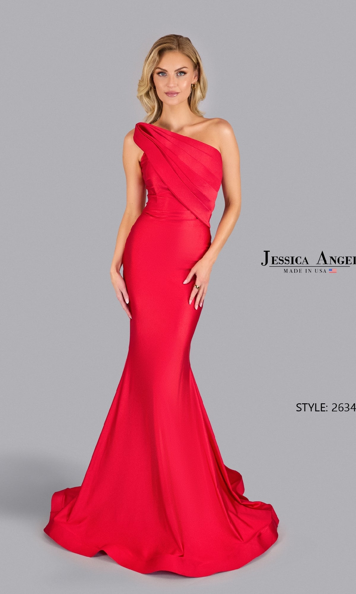 A woman poses against a plain gray background in a fitted, floor-length strapless mermaid prom gown, Jessica Angel 2634.